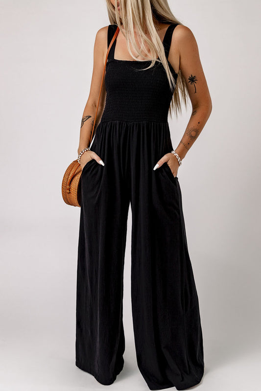 Black Smocked Sleeveless Wide Leg Jumpsuit with Pockets


		This shirred jumpsuit fits most body shapes with elasticity
	
	
		Featured with a square neckline, sleeveless, ruched waist, wide leg, and side pocket
	
BottomsDalilly Designs BoutiqueBlack Smocked Sleeveless Wide Leg Jumpsuit