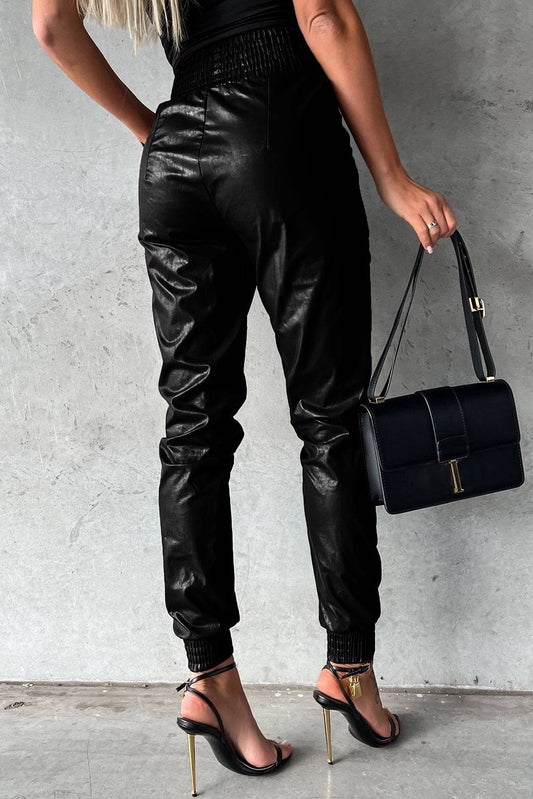 Black Smocked High-Waist Leather Skinny Pants


		The casual joggers accentuate your curves and flatter your silhouette
	
	
		Crafted from high-quality faux leather for a sleek and stylish look
	
	
		SmBottomsDalilly Designs BoutiqueBlack Smocked High-Waist Leather Skinny Pants