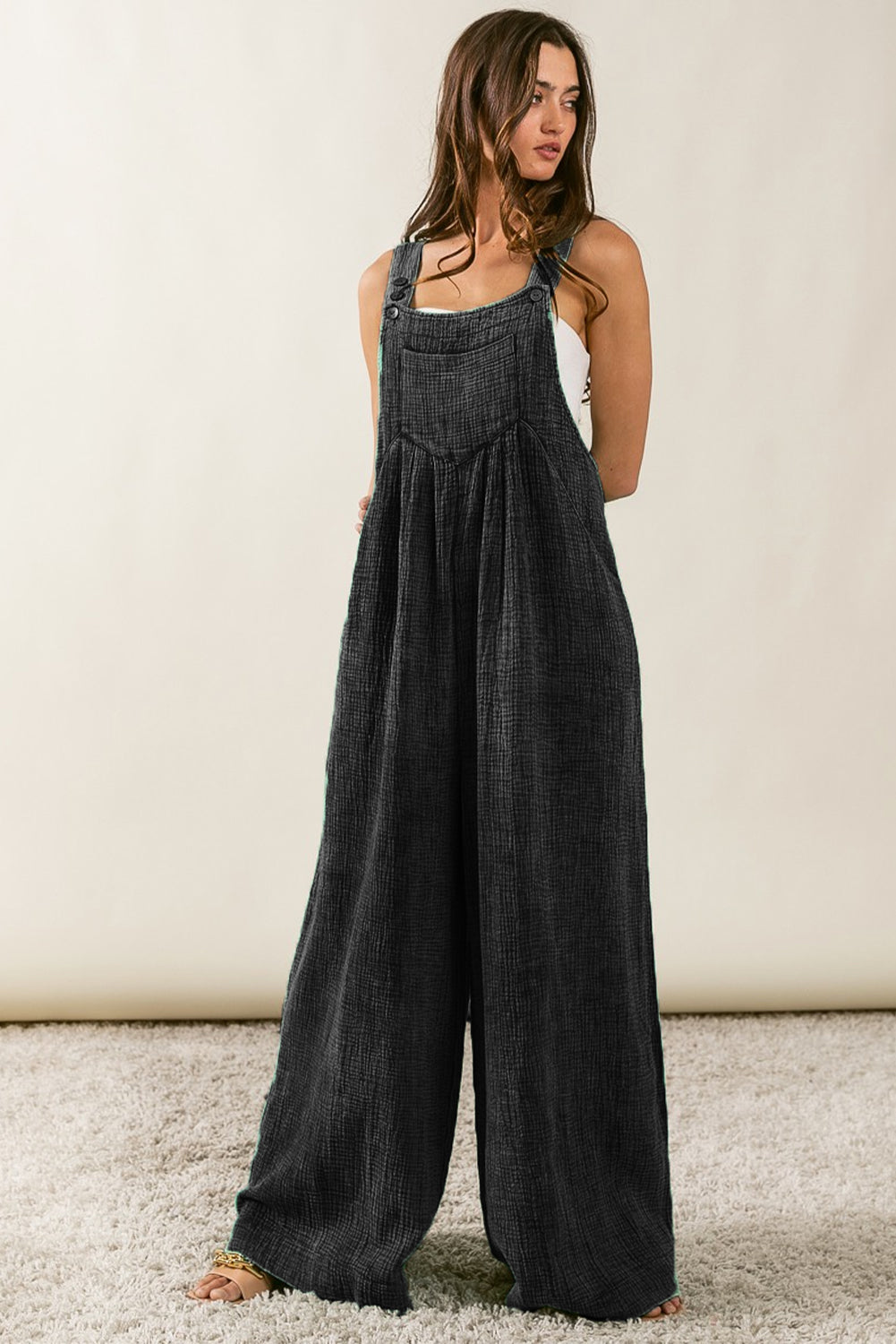 Black Textured Wide Leg Overalls

	Make a statement in these fashion-forward overalls
	Featuring a textured fabric and wide leg silhouette, you'll be comfy all day
	The side and chest pockets desiBottomsDalilly Designs BoutiqueBlack Textured Wide Leg Overalls