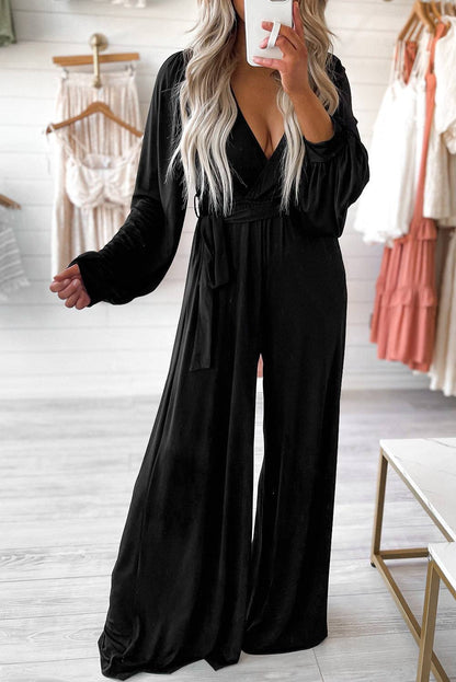 Black Cutout Back Belted V Neck Wide Leg Jumpsuit


		This high waist jumpsuit is perfect for both formal occasions and casual outings
	
	
		The wide leg design creates a flowing and elegant silhouette
	
	
BottomsDalilly Designs BoutiqueBlack Cutout Back Belted